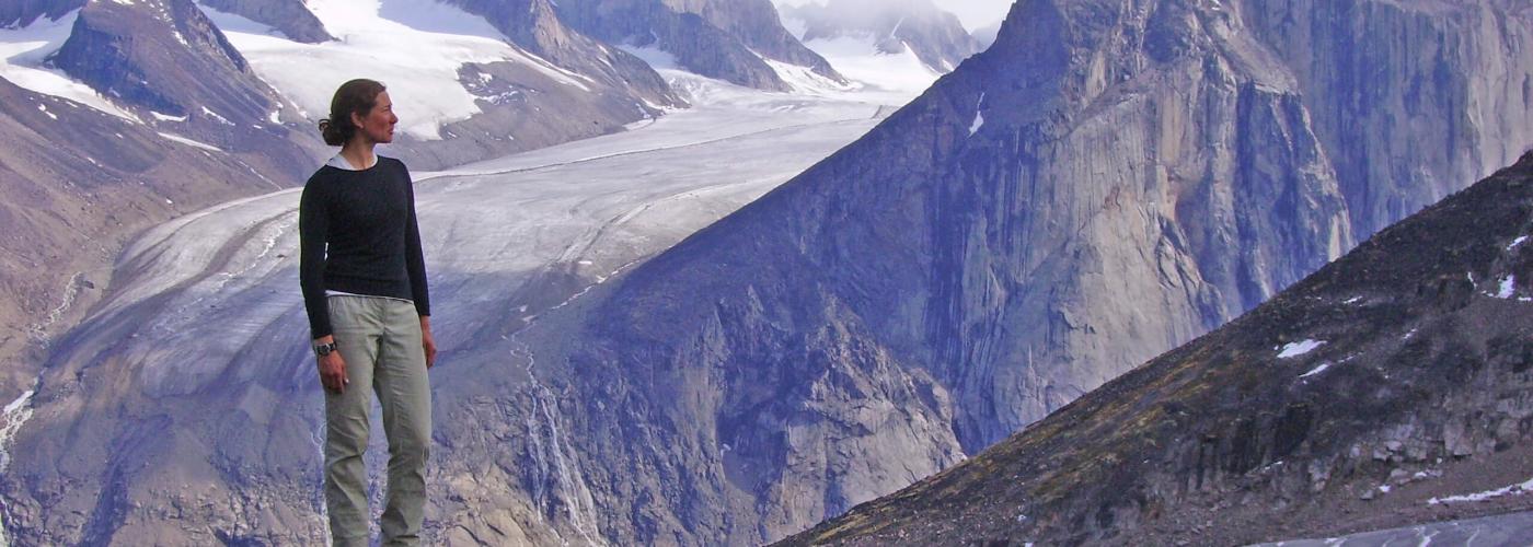 Hiker standing on ridge overlooking icefield glaciers