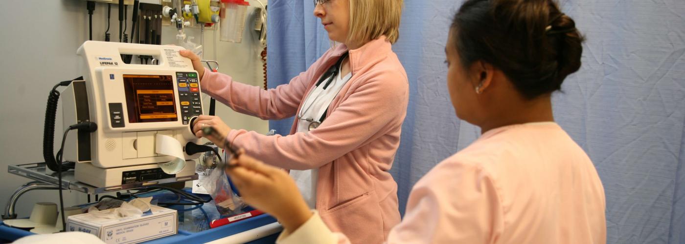 Two nurses working with hospital machine readings